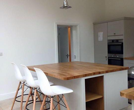 Garage Renovation Construction site with scaffolding, signage, and a portable toilet.